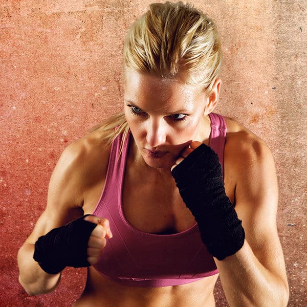 Mixed Martial Arts Lessons for Adults in Austin TX - Lady Kickboxing Focused Background