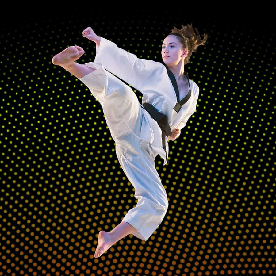 Martial Arts Lessons for Adults in Austin TX - Girl Black Belt Jumping High Kick