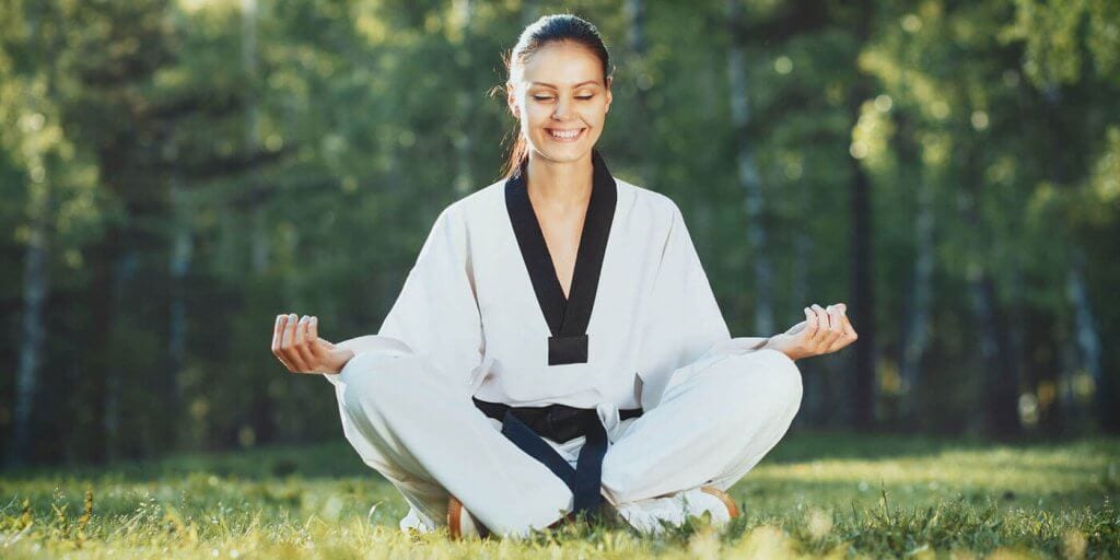 Martial Arts Lessons for Adults in Austin TX - Happy Woman Meditated Sitting Background